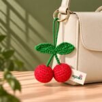 Red Cherry crochet keychain in a lifestyle setting