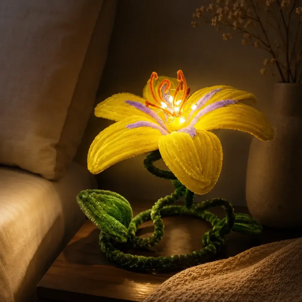 Glowing yellow flower lamp with purple accents and a curled green stem