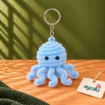 Fluffy blue pipe cleaner octopus keychain with beaded eyes, curly tentacles and silver-tone keyring by Ayzalo