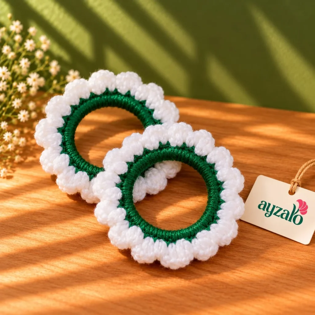 Pair of Ayzalo jasmine crochet gajra bangles with green wrapped bases and white scalloped petals