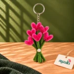 Mini bouquet heart flower keychain with bright pink heart-shaped blooms, green stems and pearl accent by Ayzalo