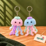 Ocean Glow pastel pipe cleaner jellyfish keychains with pink and blue hoods, contrasting crowns and colourful tentacles by Ayzalo