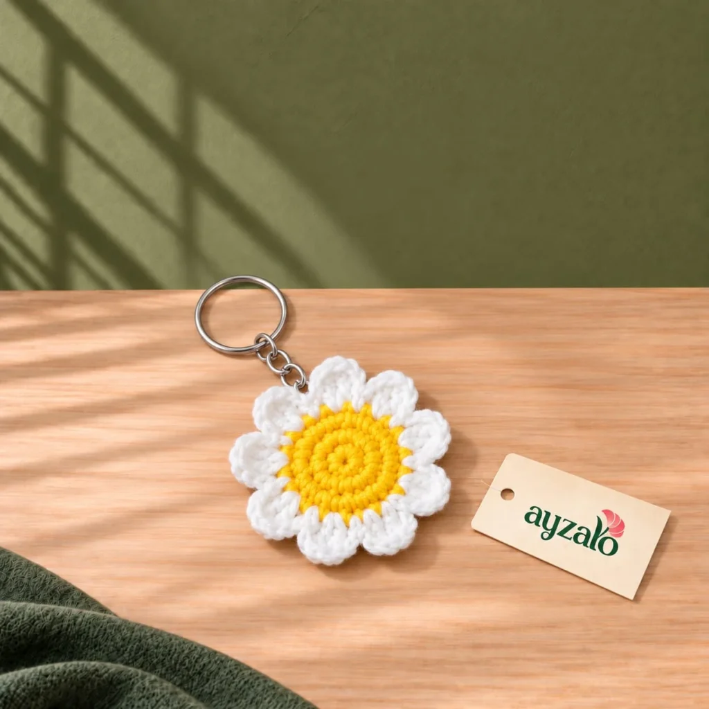 Sunburst daisy crochet keychain with yellow centre, white scalloped petals and silver-tone keyring by Ayzalo