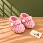 Bubblegum pink handmade crochet baby shoes with buttoned Mary Jane straps by Ayzalo